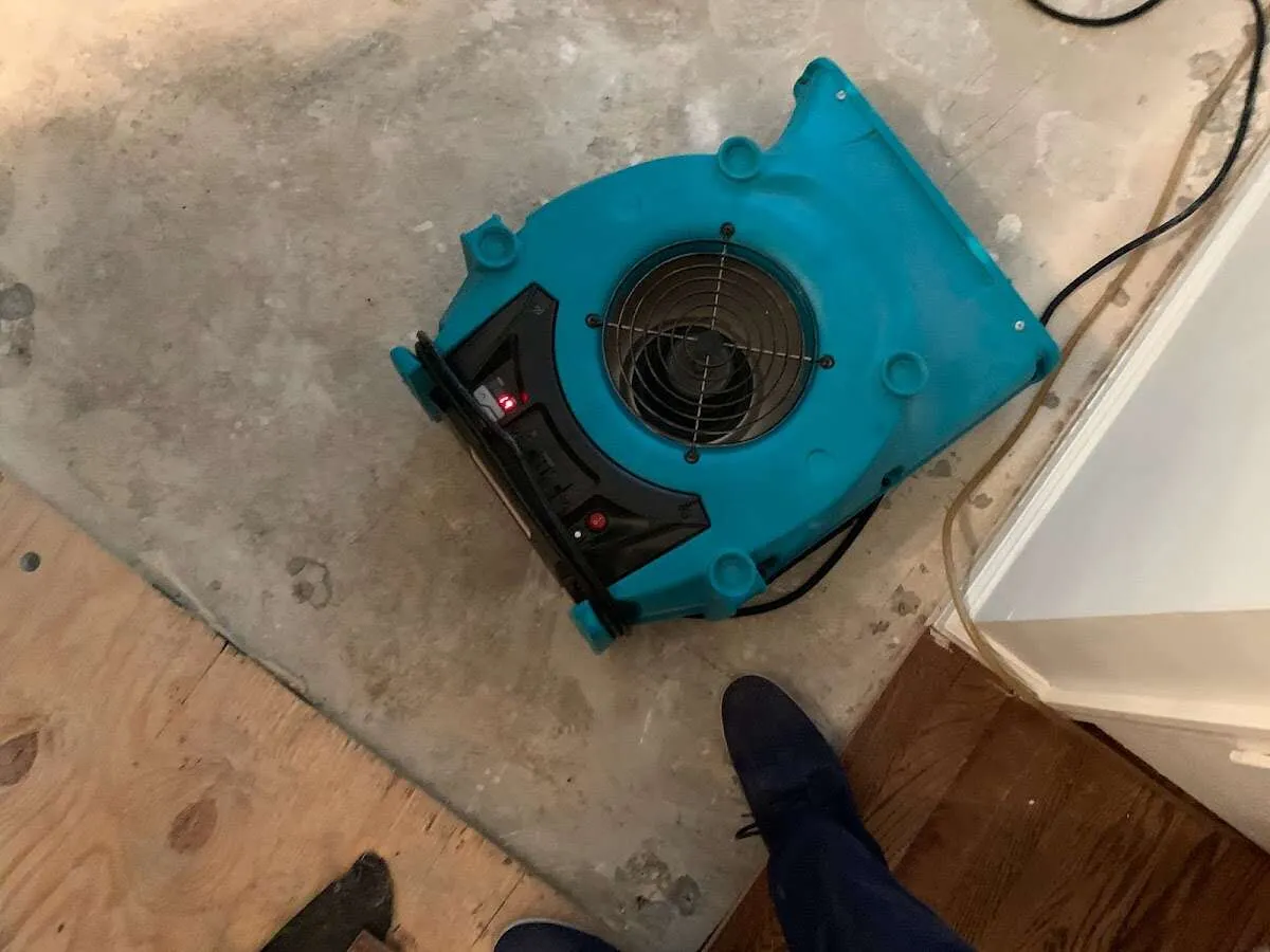 Air mover drying subfloor during Commercial Water Damage Restoration in Basehor
